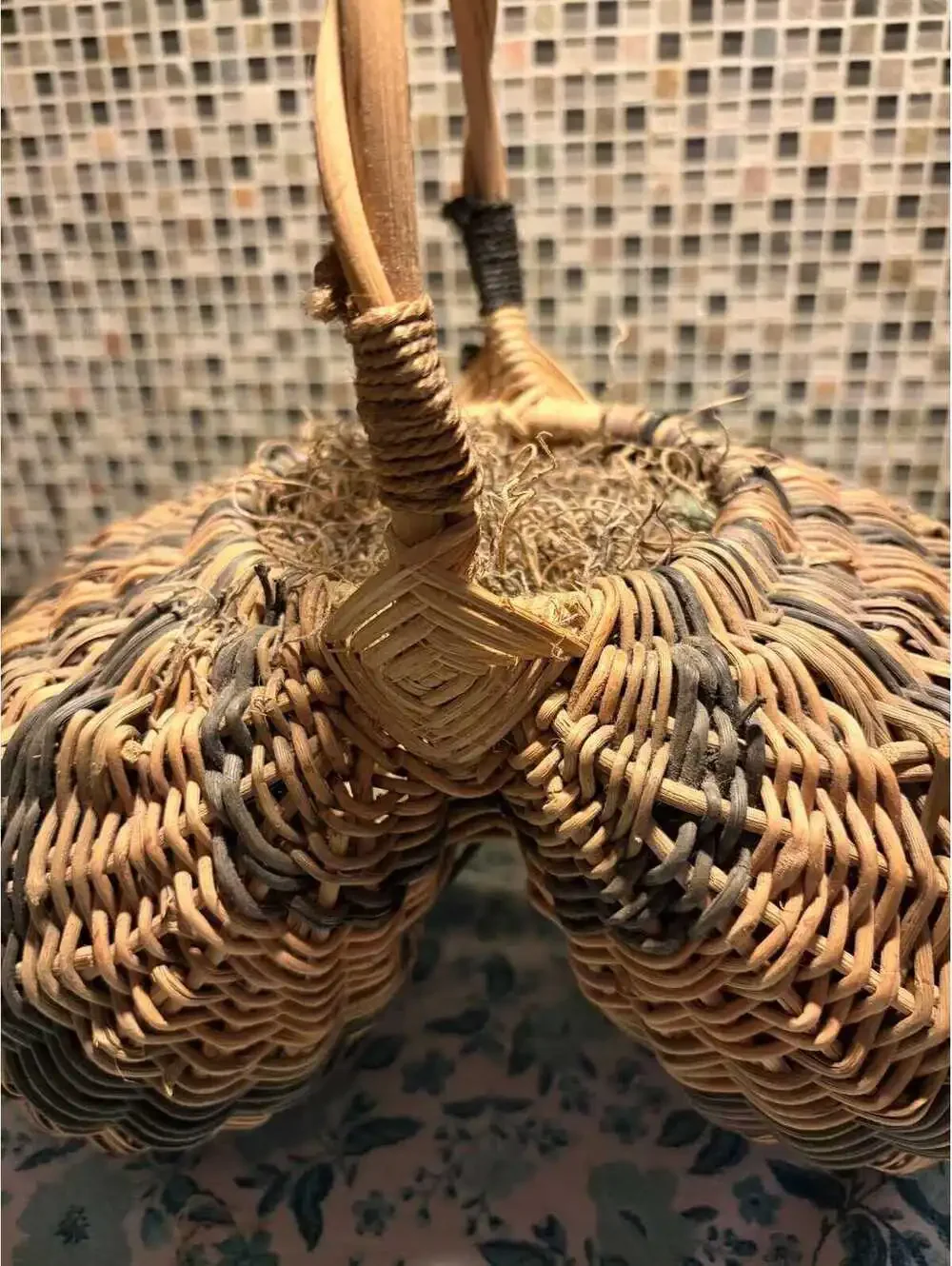 This is a vintage hand-woven double buttocks wicker harvest basket.